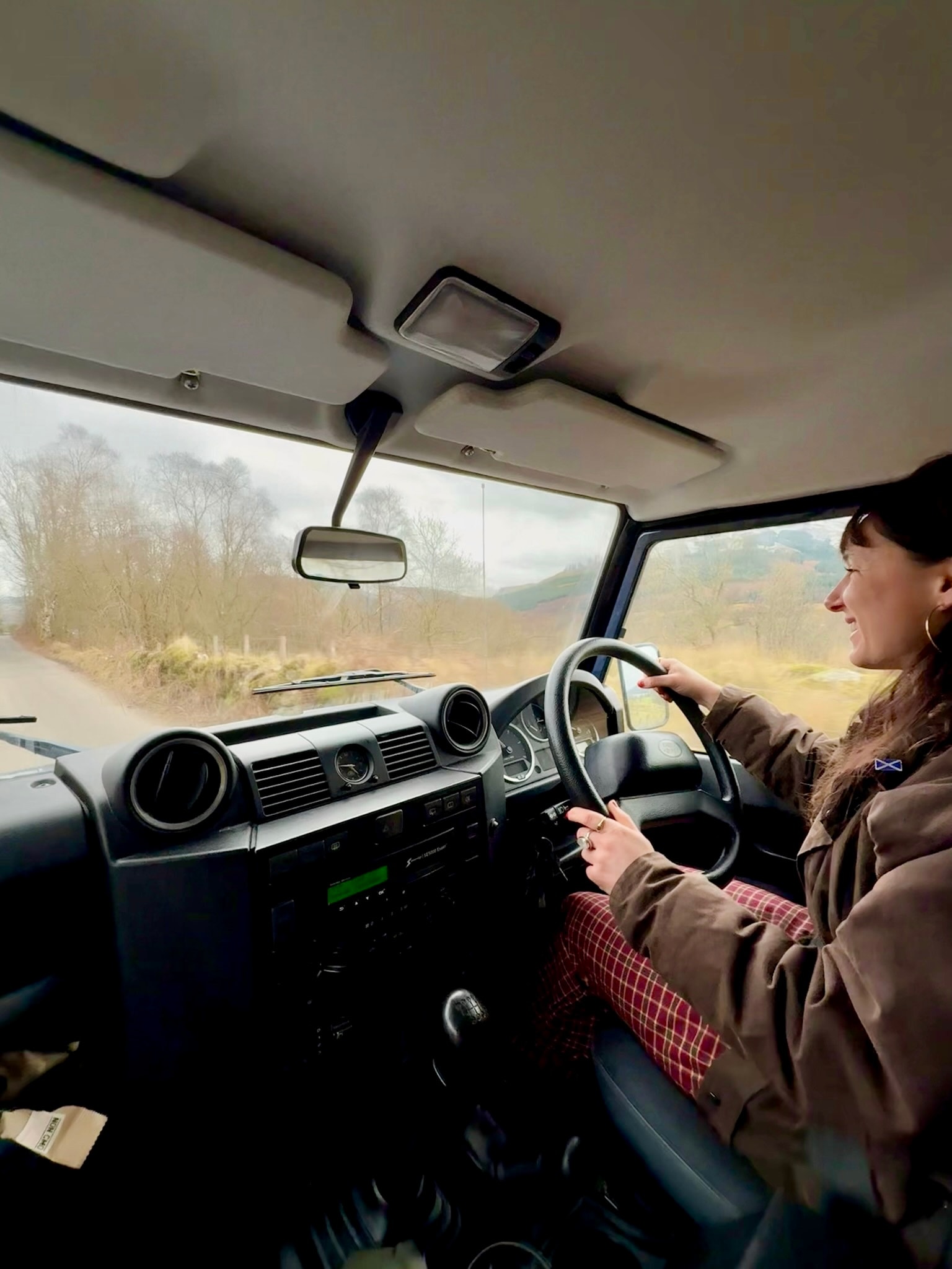 Beth driving the Land Rover through the Scottish countryside